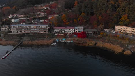 aerial backwards reveal shot over houses at lake kawaguchiko in japan