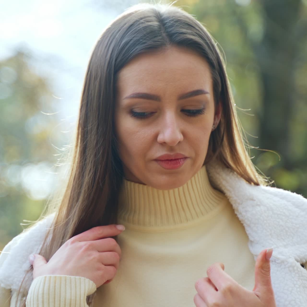 Elegant cheerful woman with phone. Portrait of pretty young lady on autumn background