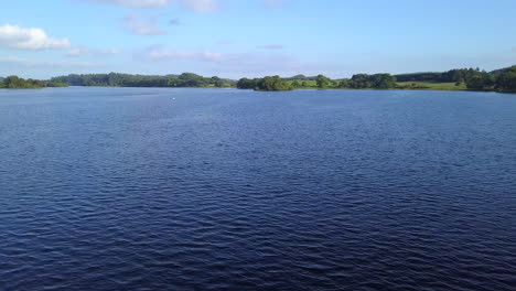 Drone-flies-low-over-Loch-Ken,-Dumfries,-Scotland