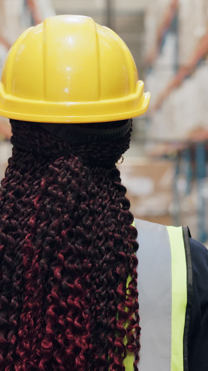 Woman Wearing Hard Hat in Warehouse