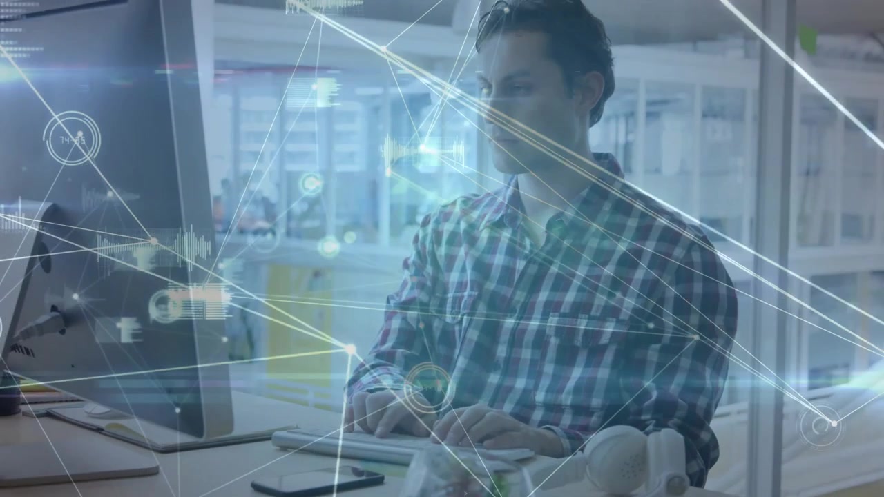 Man picking up smartphone and typing on keys while reviewing tech data with HUD around screen