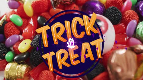 Animation-of-halloween-trick-or-treat-text-over-sweets-background