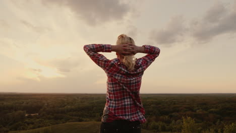 the silhouette of a sportswoman standing at sunset while the sun illuminates her figure 1