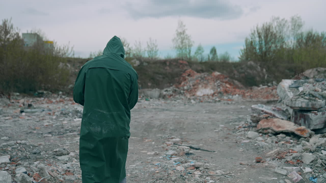 Worker in special chemical protective suite. Man in chemical protection abandoned in abandoned factory