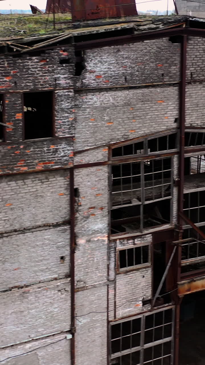 Abandoned building during war time. Destroyed building with broken windows. Exterior of ruined architecture. Vertical video