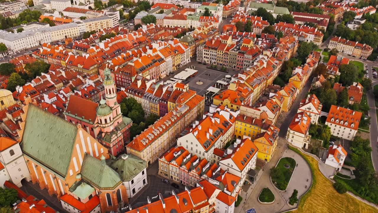 Cinematic drone view, Warsaw Old Town square shapes under soft sunset glow
