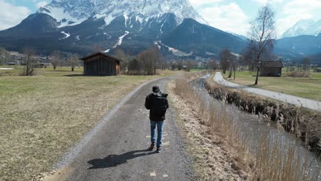 I-am-walking-in-winter-on-a-trail-towards-a-high-snowy-mountain-in-austria,-the-peak-is-called-Zugspitze