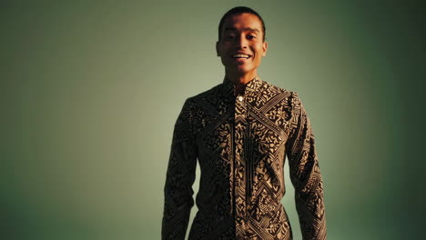 expressive young man in patterned shirt in studio