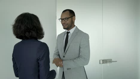 two business people meeting near door and talking