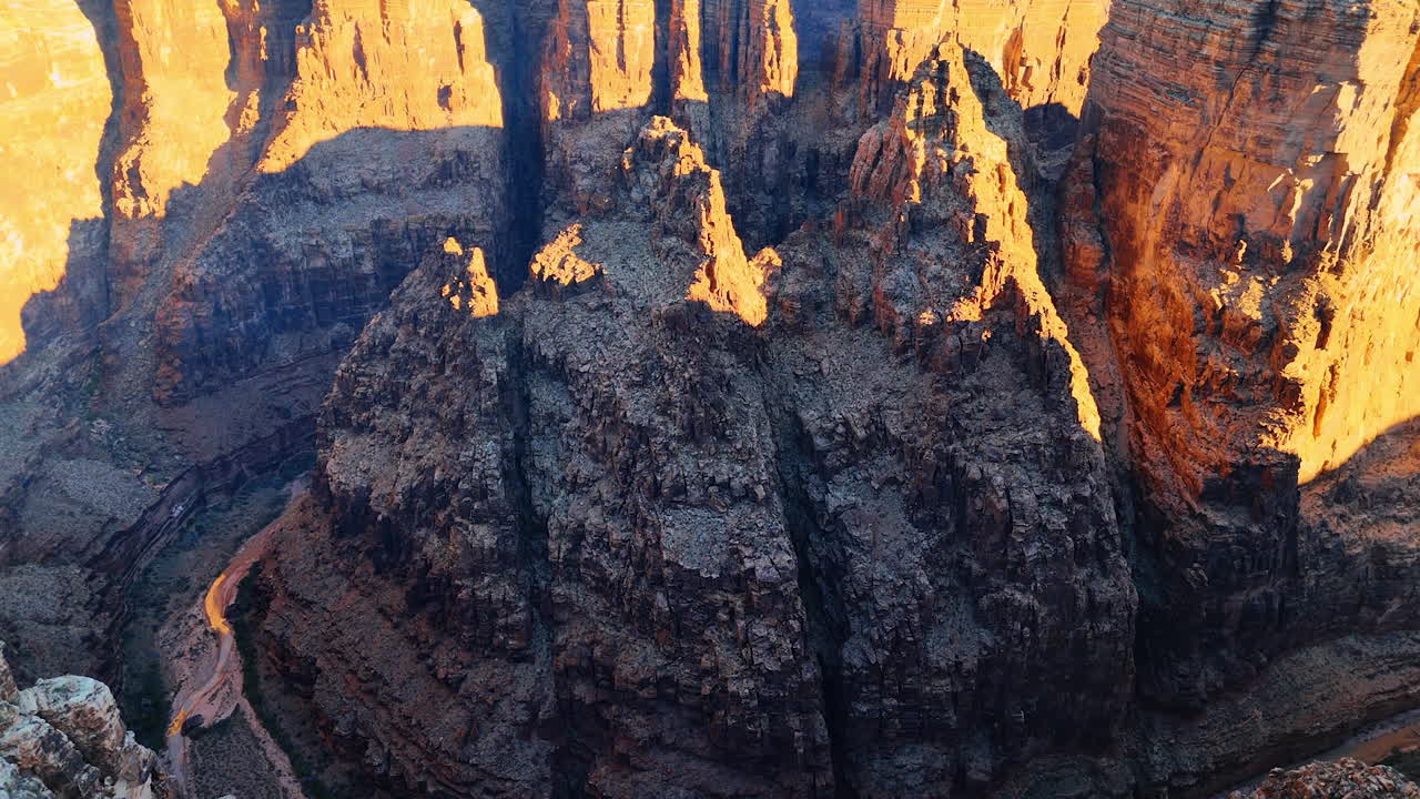 Going up in the deep canyon along the fantastic rocks. Thin river flows below. Stunning Marble Canyon, Arizona, USA from drone