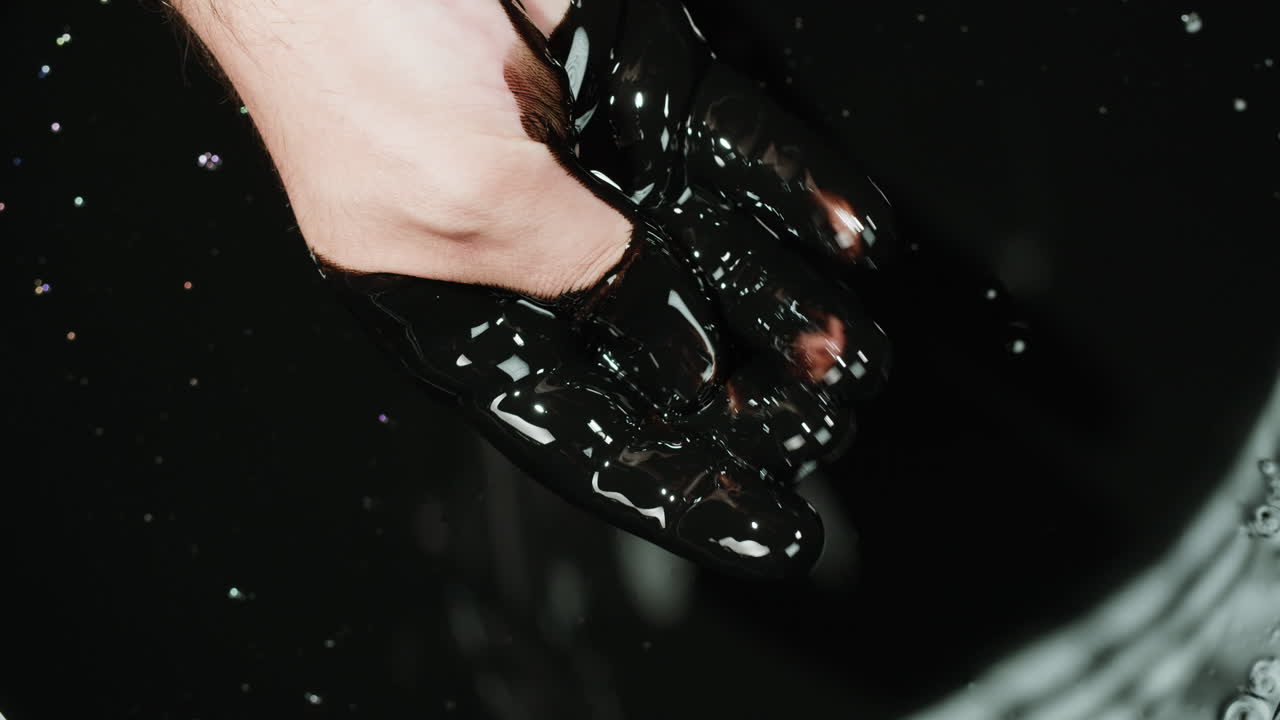 Hand Covered in Black Oil