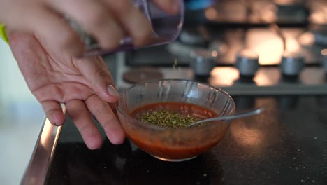 preparing tomato sauce with herbs