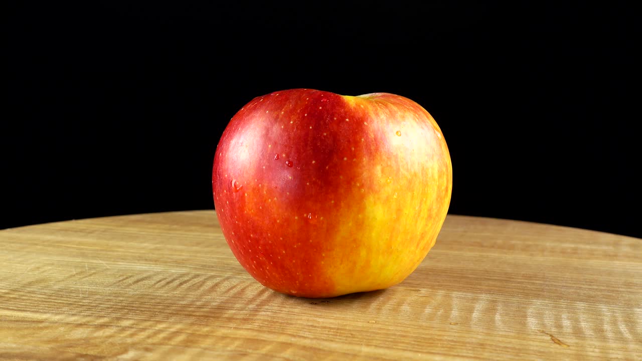 Æbler på sort baggrund. Skærebræt i bevægelse.