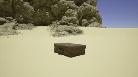 old suitcase placed on sand surrounded by rocky formations in bright sunlight