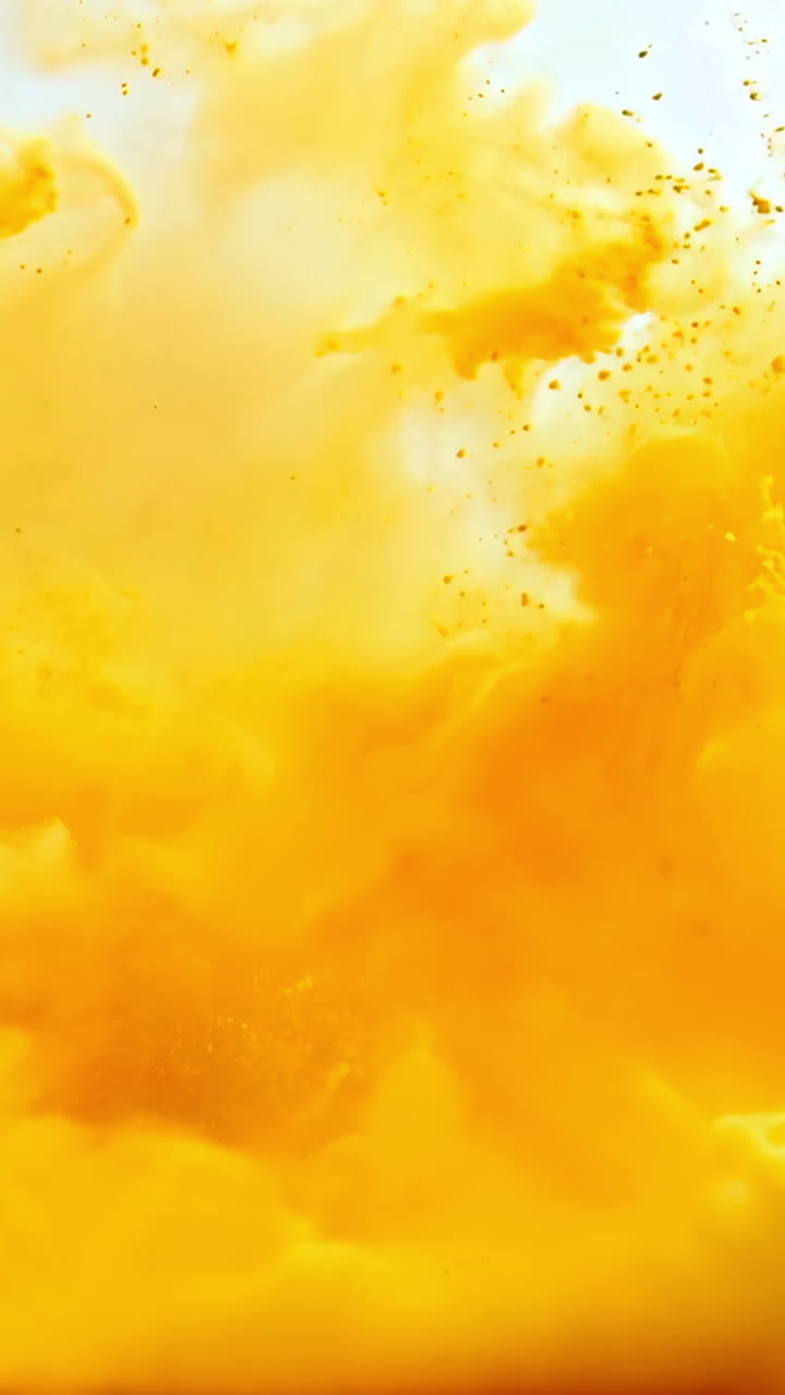 A large orange cloud of smoke is billowing out of a fire. The smoke is thick and billowing, creating a sense of chaos and destruction. The orange color of the smoke contrasts with the white background