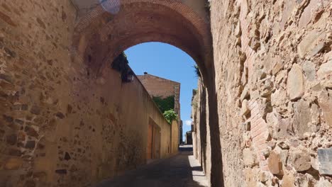 tilt down shot of narrow stone alleyway in caceres old town, spain