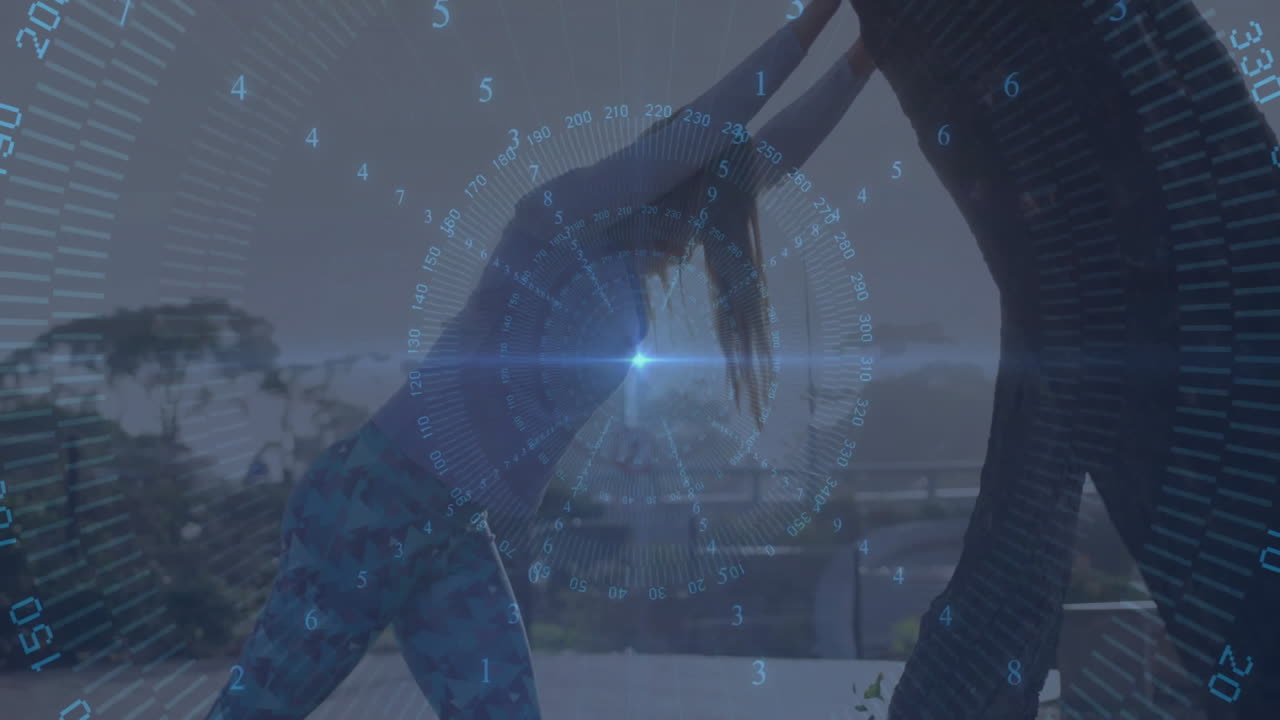 Two women doing partner yoga on wooden terrace, showing fitness tech HUD overlay with numbers