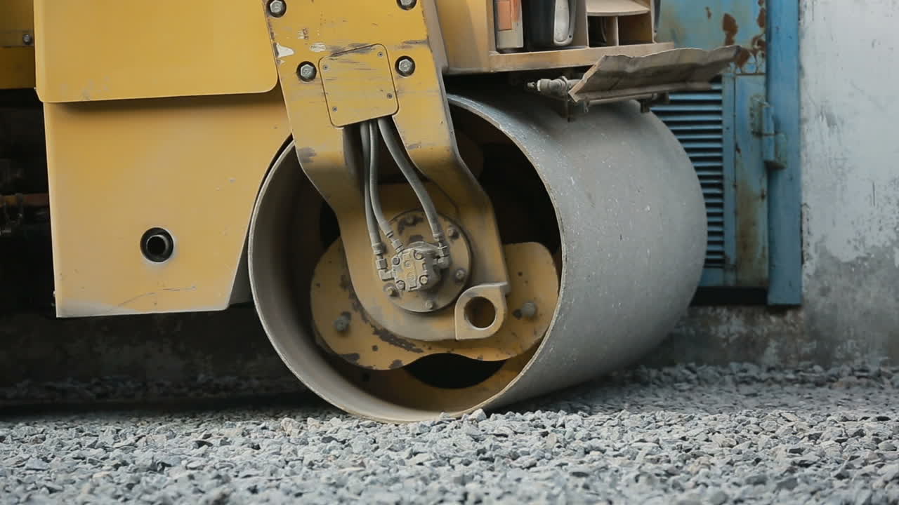 Road roller working on the new road construction site