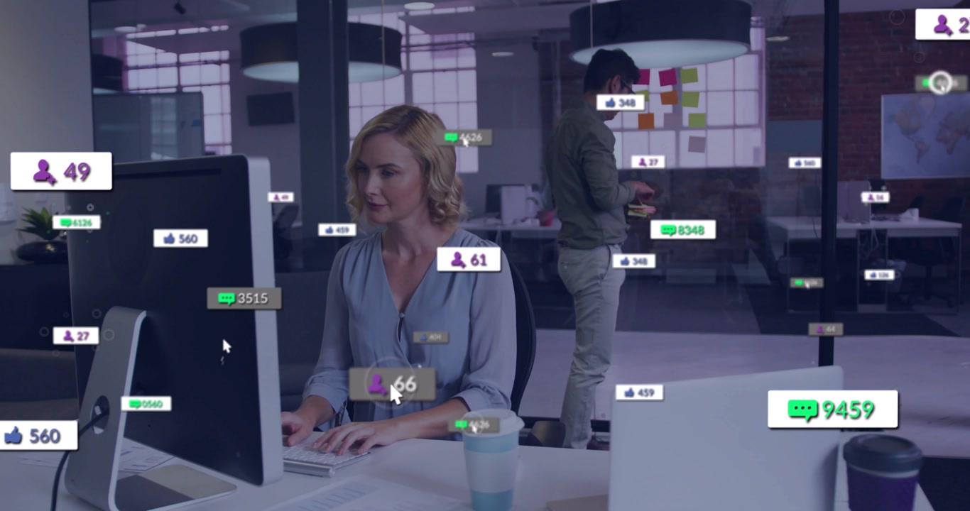 Woman typing and growing social badges over desk man placing notes on glass showing marketing KPIs