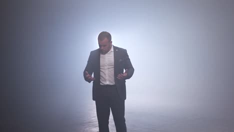 businessman in a suit in a foggy studio environment