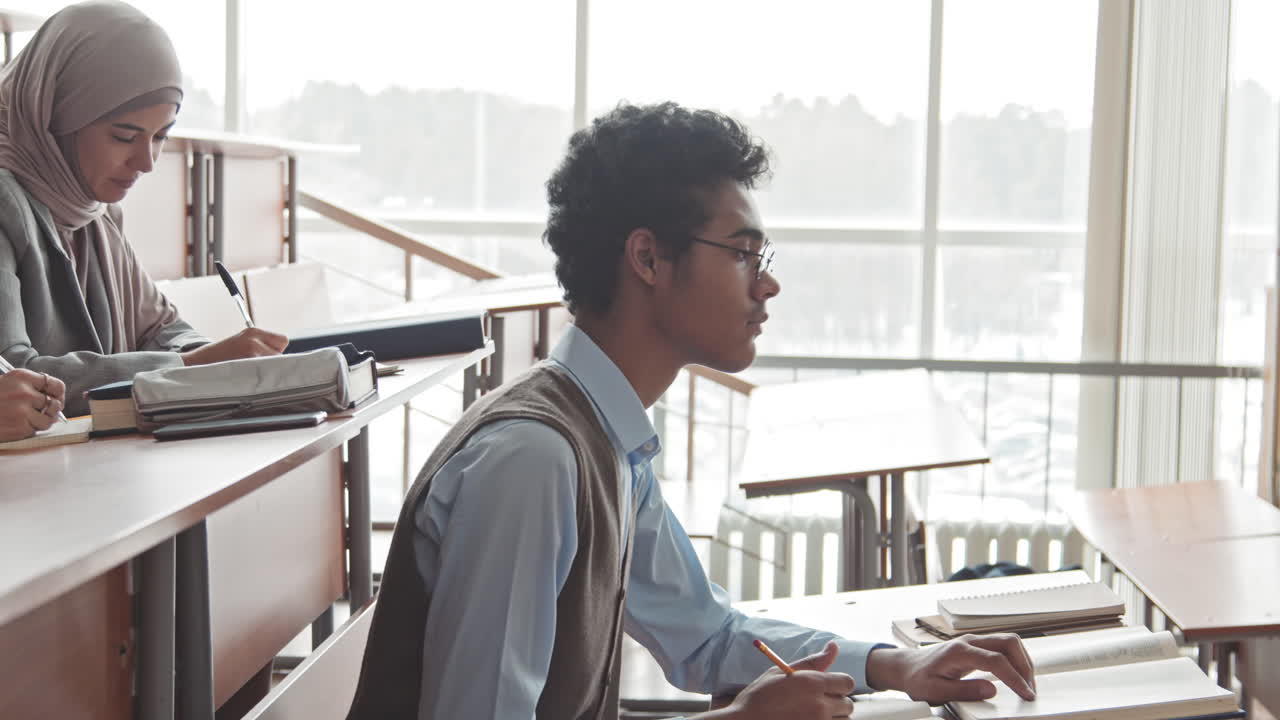 Multi-Ethnic Students Studying in Lecture Hall