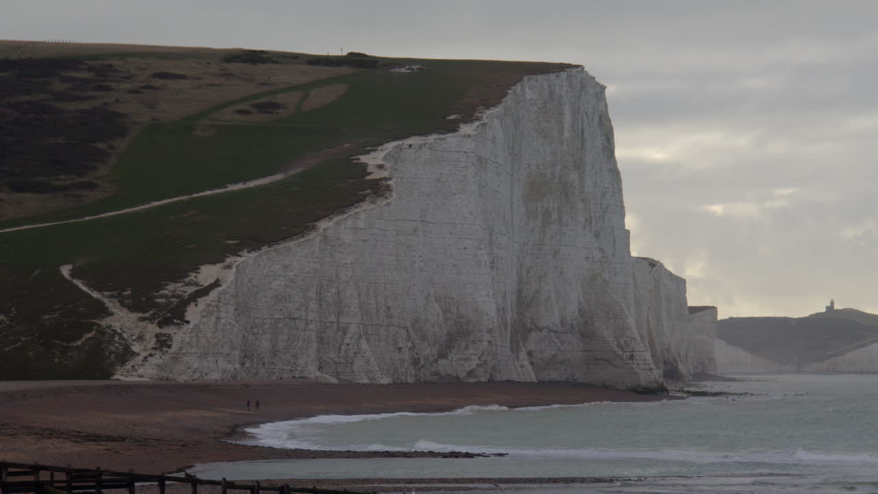 Wide shot of Seven Sisters Cliff in the morning with belle tout lighthouse in background at Cuckmere haven beach next to Seaford head