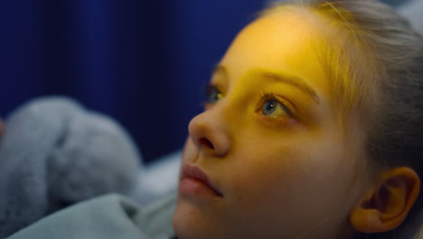 closeup girl medical examination in hospital unit. upset little patient in ward.