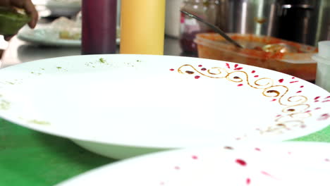 Drawing-and-decorating-food-plates,-close-up