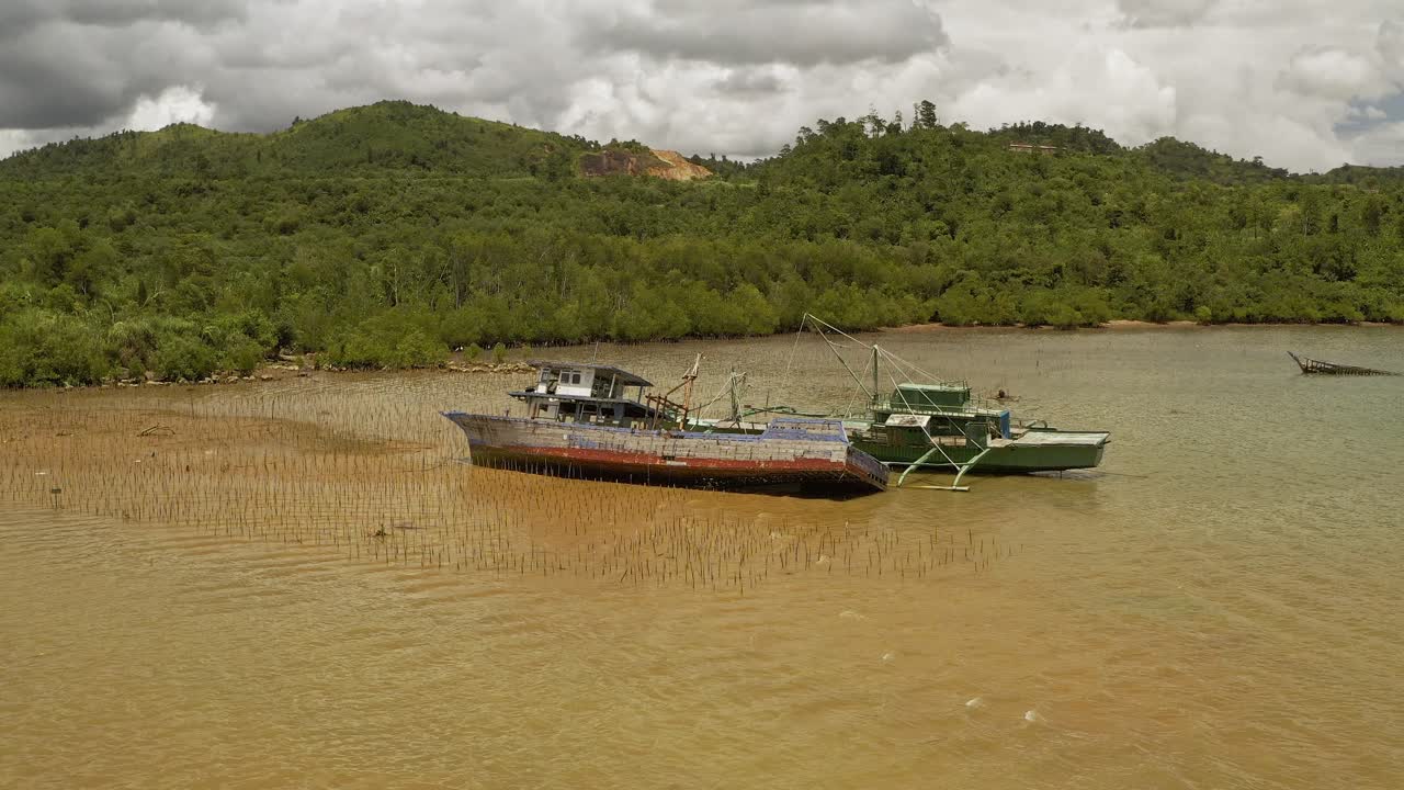 Aerial Orbital View of Shipwrecked Fishing Vessels Stranded in Shallow Waters Along the Coastal Surigao, Philippines