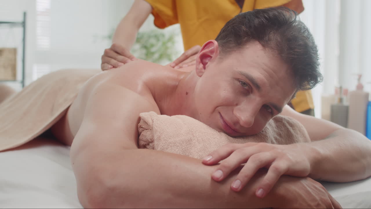 Relaxed Man Getting Massage and Looking at Camera