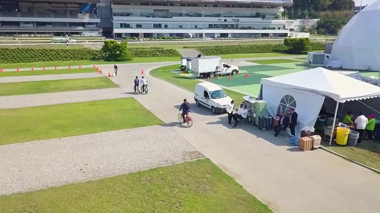 A drone following a biker inside a stadium.