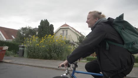 young dutch woman cycling home, with a smile on her face