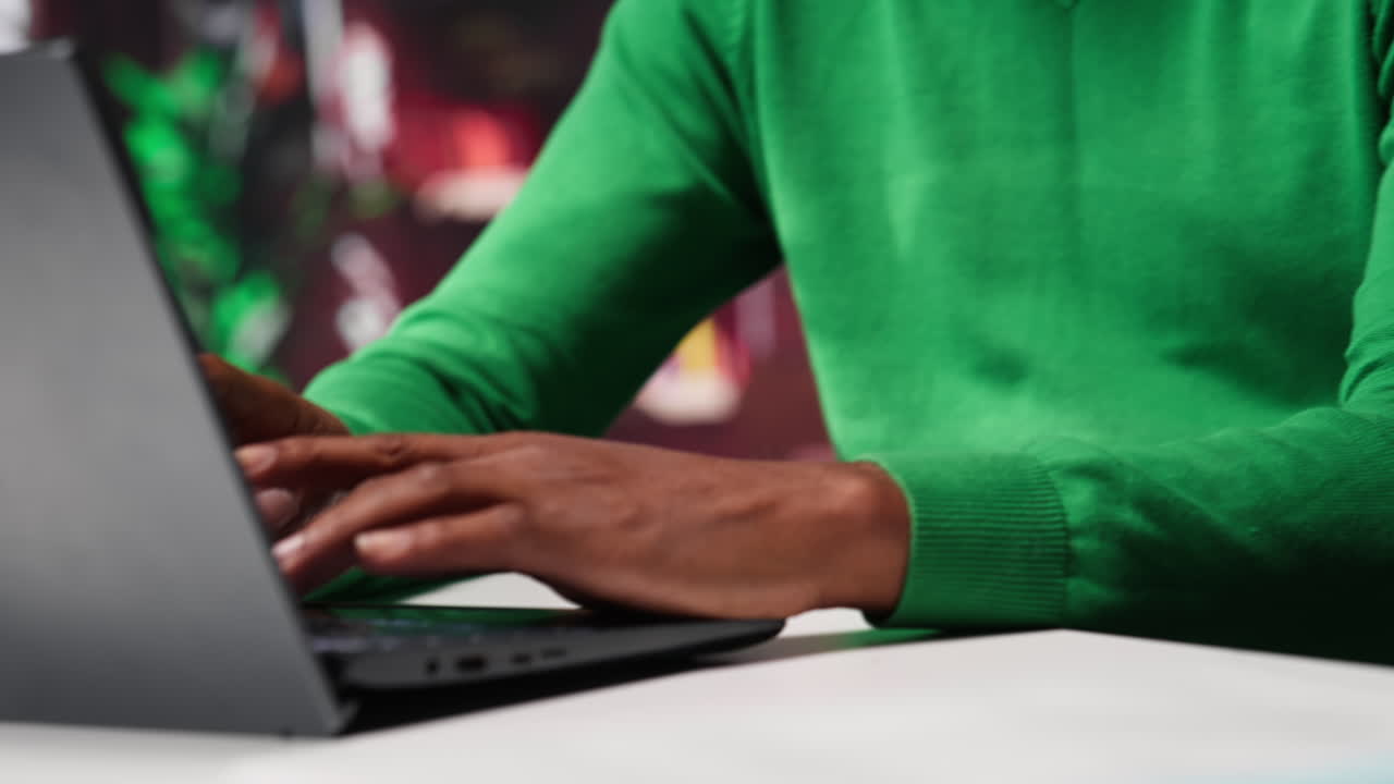 Vertical Video African american freelancer at home office sitting at desk and typing on laptop