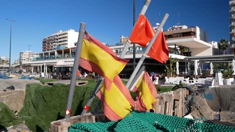 spanish beach restaurant with fishing nets and flags