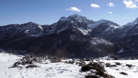 Beautiful-snowy-mountain-landscape-in-Kolasin,-Montenegro-with-blue-skies-and-a-few-feathery-clouds-on-a-sunny-day