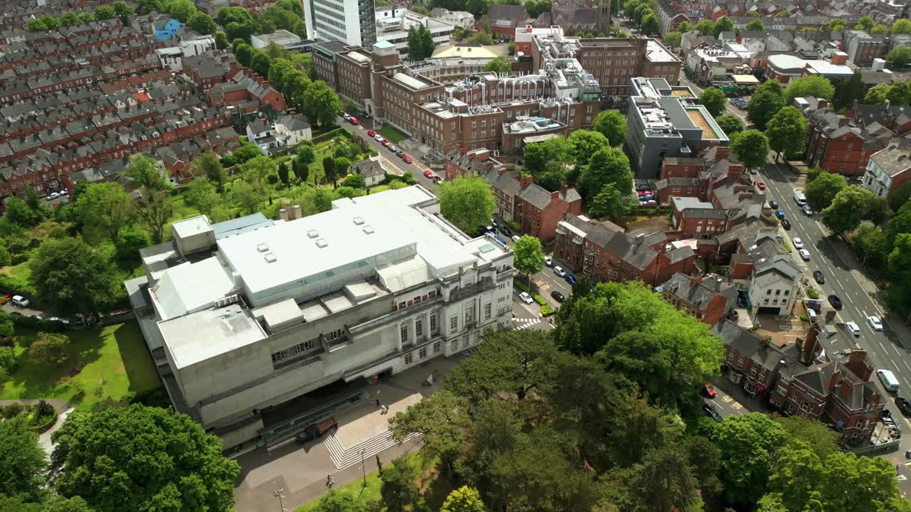 Wide overhead aerial video of Ulster Museum in Botanic Gardens in Belfast, Northern Ireland on a bright sunny day. Produced in 4K, 60 frames per second and with Rec709 color.