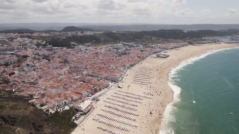 aerial circular view of wide nazarè beach