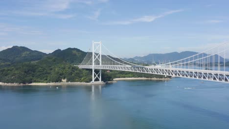 aerial tilt reveals warm island scene at bridge in hiroshima japan