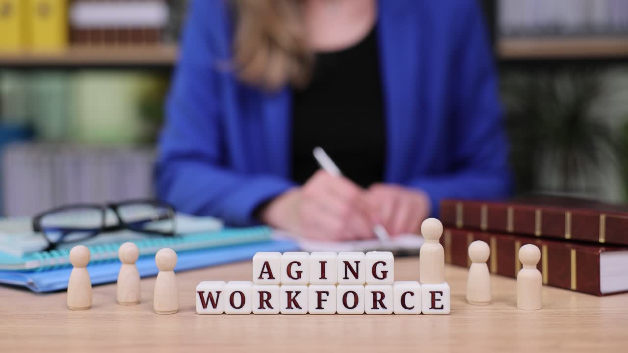 Aging Workforce Concept with Wooden Figures and Office Setting