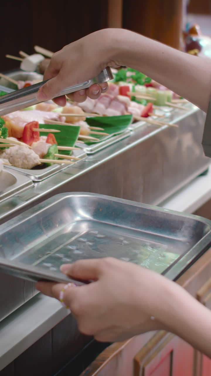 Unrecognizable Person Having Meat Skewers for Lunch at Local Food Market