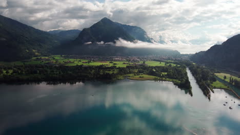 Aerial-view-of-the-clear-Thunersee-in-the-mountain-valley-of-Interlaken-in-Switzerland