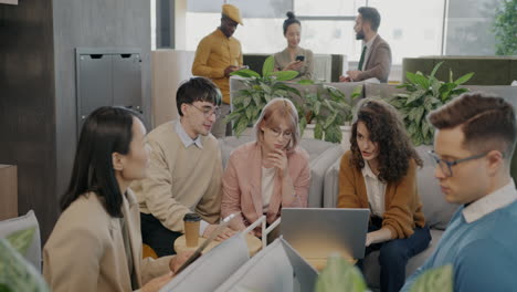 Coworkers in a Modern Office Discussing Projects