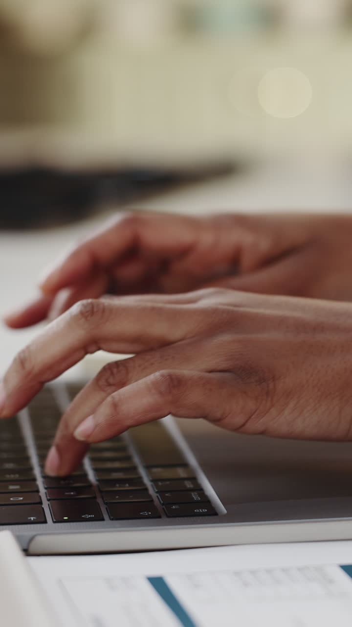 Close-up of Hands Typing on Laptop Keyboard