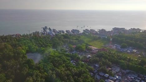 Aerial-flight-towards-forest-and-ocean-in-Malaysia,-wide-distance-shot-moving-forward-in-slow-motion