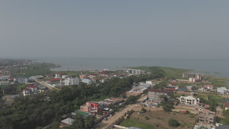 sideways flying drone shot above bujumbura burundi africa looking over the houses and lake tanganyika with mist and pollution in the air log