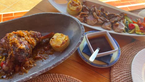 Delicious-leg-of-lamb-with-vegetables-and-potatoes,-tasty-steak-at-a-meat-restaurant-in-Spain,-4K-shot