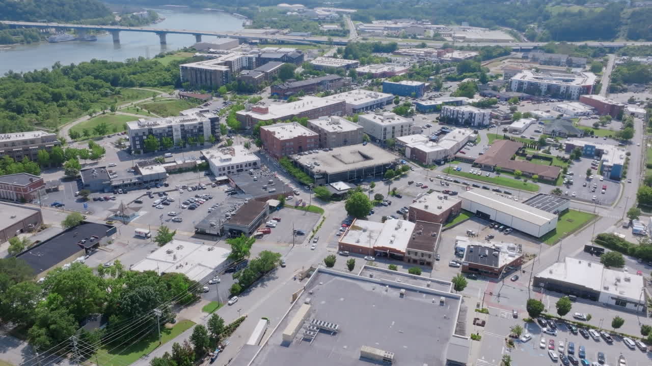 Aerial video flying over buildings and traffic on the north shore of Chattanooga, TN in the middle of the day.