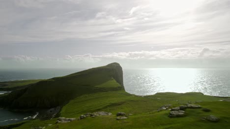 Group-Of-Friends-Looking-Out-To-Sunny-Golden-Scottish-Coastline,-Neist-Point