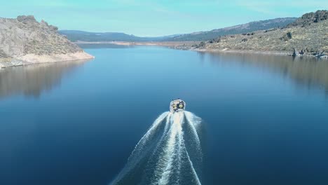 aerial over a fishing boat traveling on frenchman's lake in northern california