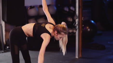 Tilt-Up-Shot-Of-Active-Young-Woman-Exercising-At-Health-Studio